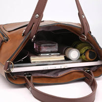 Brown Leather Handbag With Adjustable Strap And Multiple Pockets