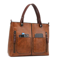 Brown Leather Handbag With Adjustable Strap And Multiple Pockets