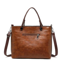 Brown Leather Handbag With Adjustable Strap And Multiple Pockets