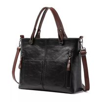 Brown Leather Handbag With Adjustable Strap And Multiple Pockets