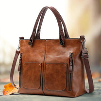 Brown Leather Handbag With Adjustable Strap And Multiple Pockets
